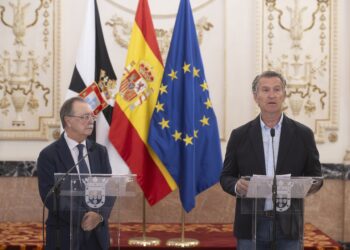 El presidente del Partido Popular, Alberto Núñez Feijóo (d), y el presidente de Ceuta, Juan Jesús Vivas (i), atienden a