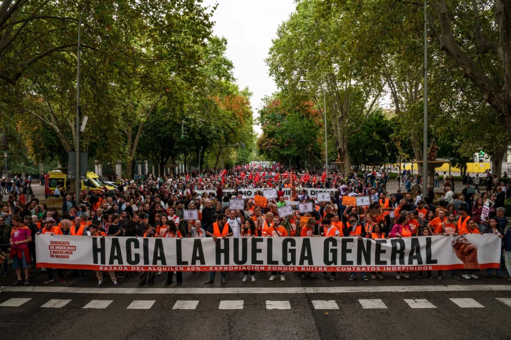 Numerosas personas sostienen una pancarta con lema 'Hacia la huelga general' durante la manifestación para exigir una re
